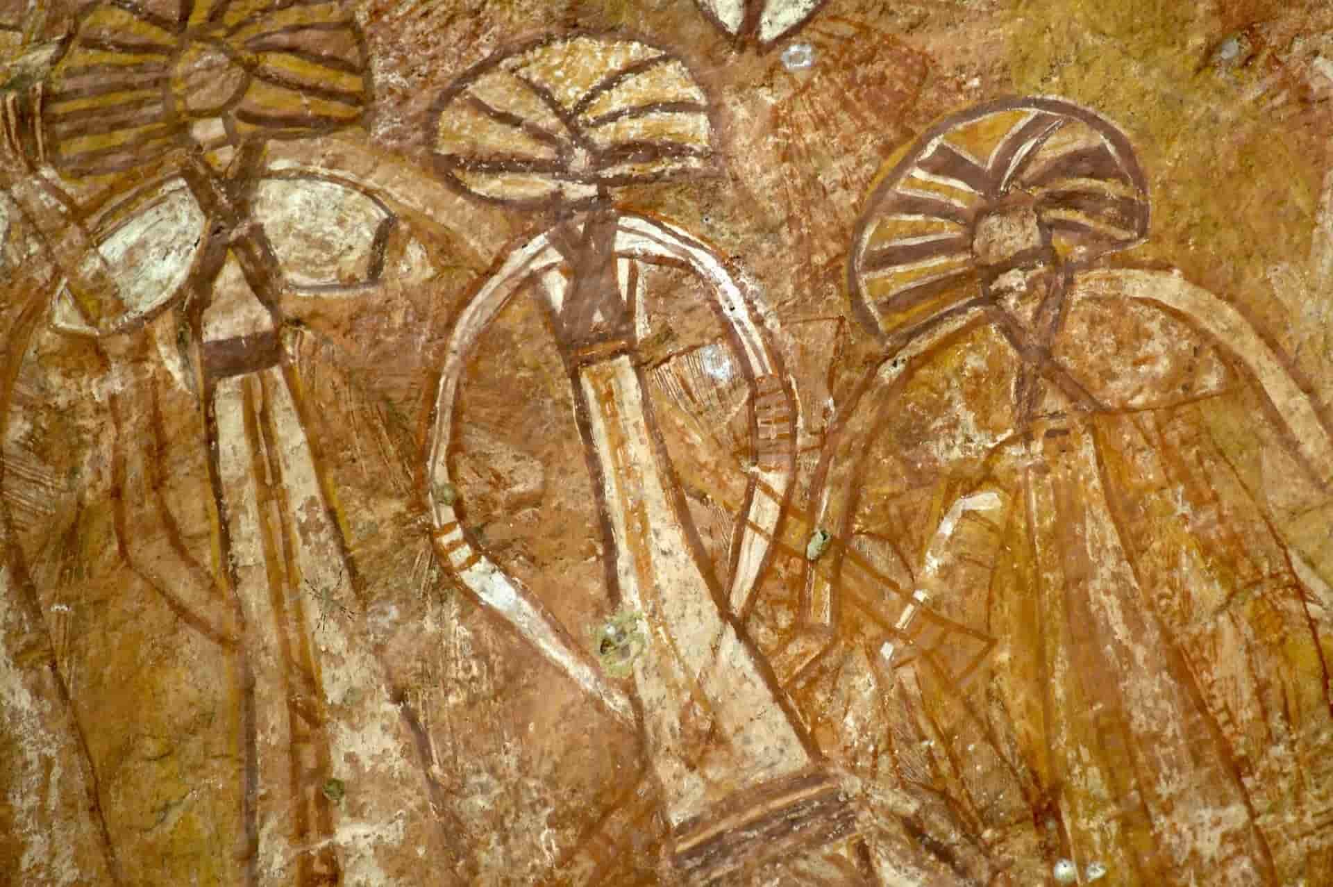 Ancient Rock Art Depicting Three Humanoid Figures Wearing Elaborate Headdresses — NT Driver Guide - Escorted Touring & Transfers in Darwin City, NT