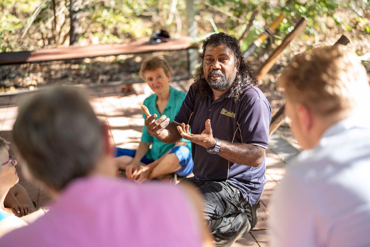 A Speaker Engages a Small Group in an Outdoor Setting — NT Driver Guide - Escorted Touring & Transfers in Darwin City, NT