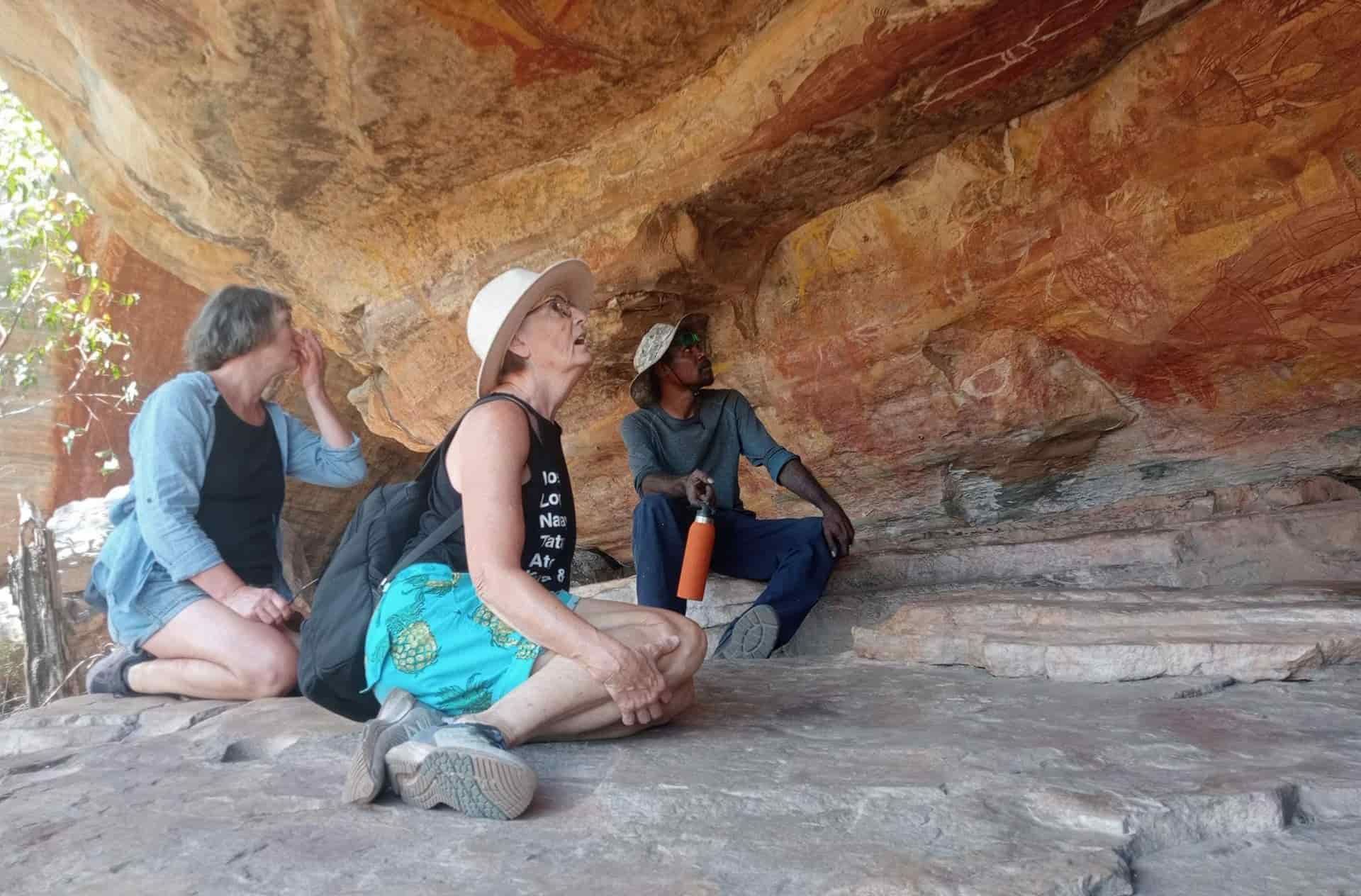 Tour Group Viewing Traditional Cave Paintings — NT Driver Guide - Escorted Touring & Transfers in Darwin City, NT