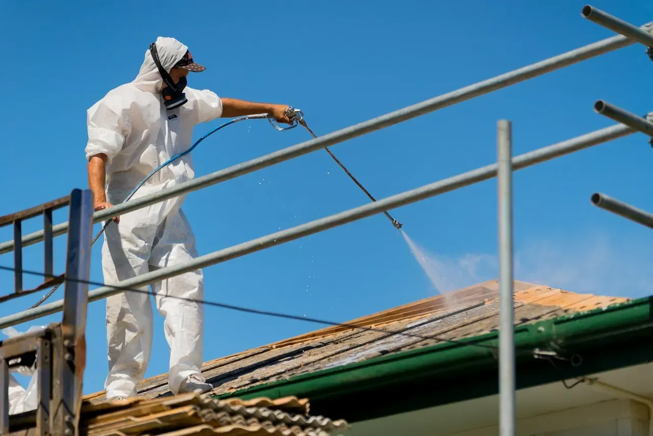 Man using a sprayer on the roof | Brisbane, QLD | Skyes Roofing