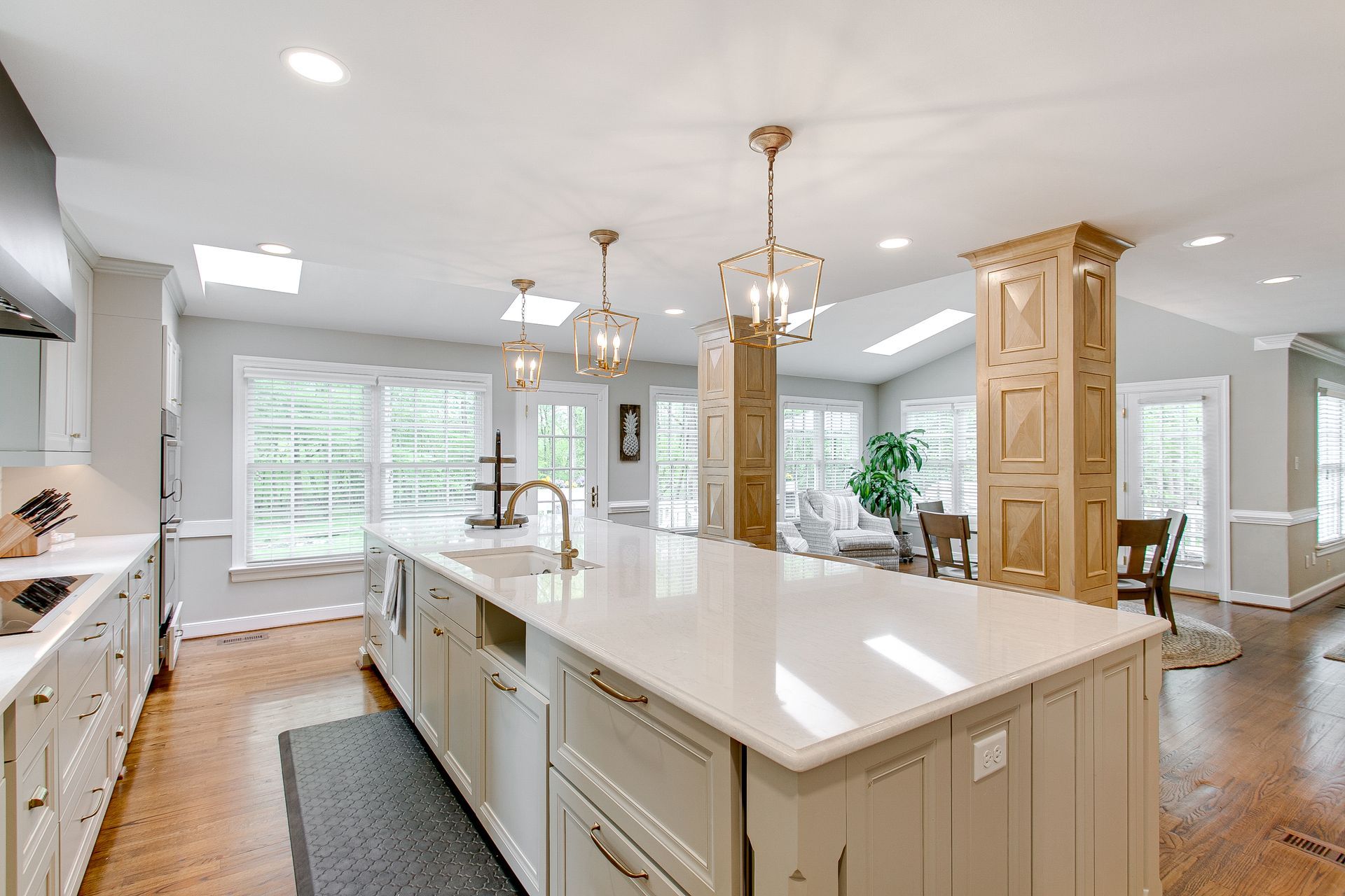 Gray kitchen cabinets with black handles beneath a countertop and kettle.