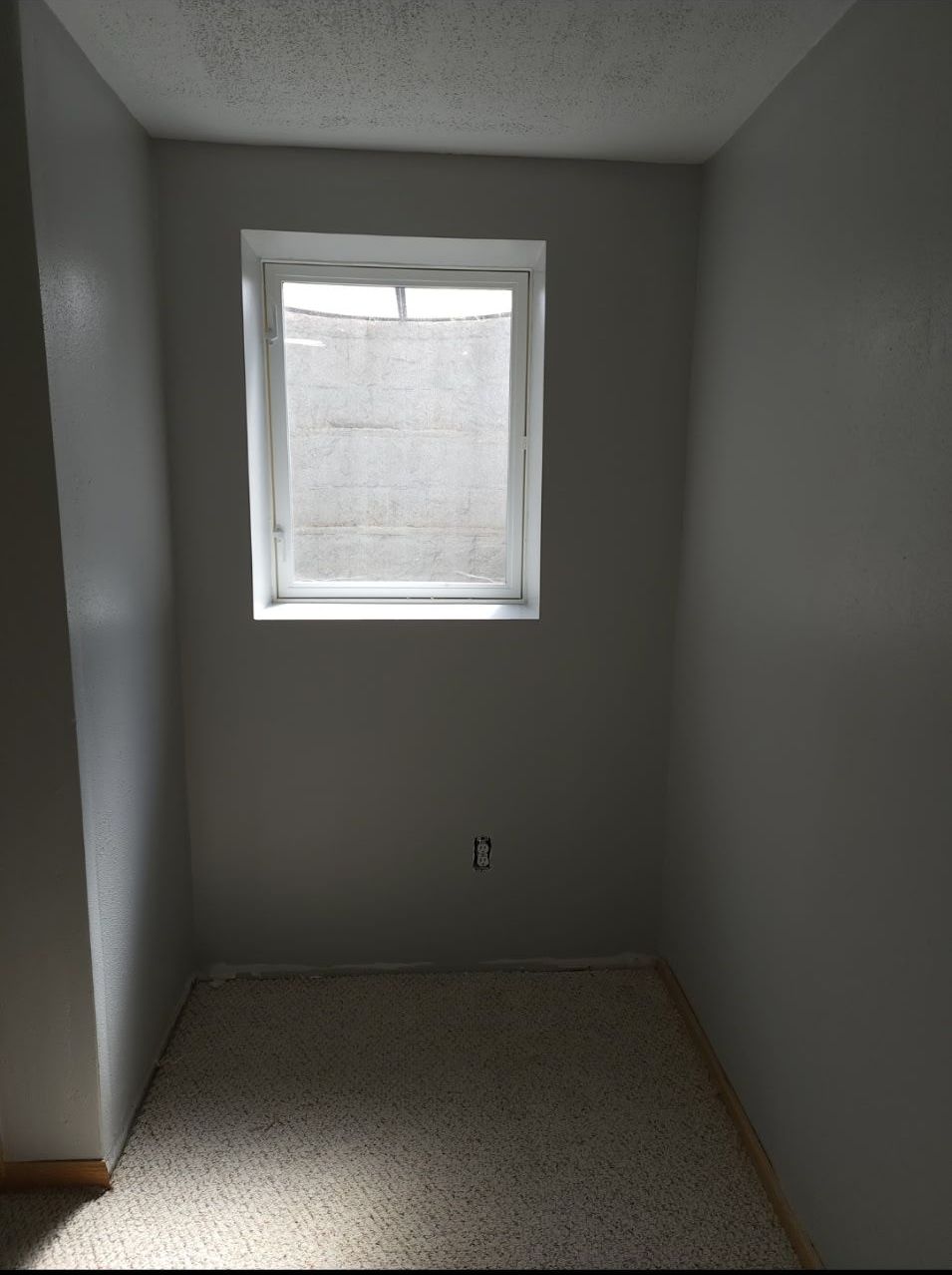 An empty room with a window in the corner