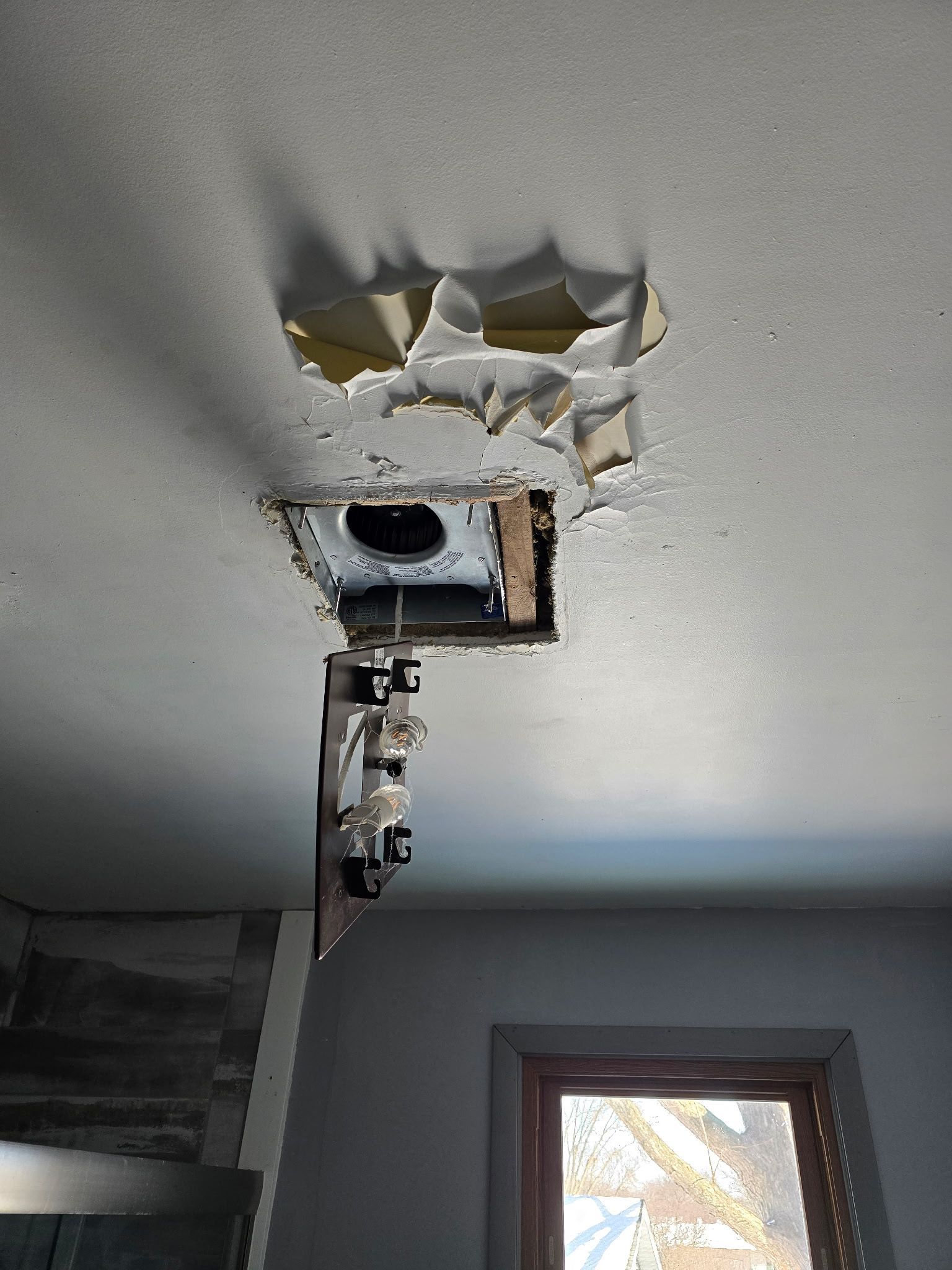 Water damaged drywall on interior ceiling in Janesville, WI, repaired by Tuescher Painting & Drywall