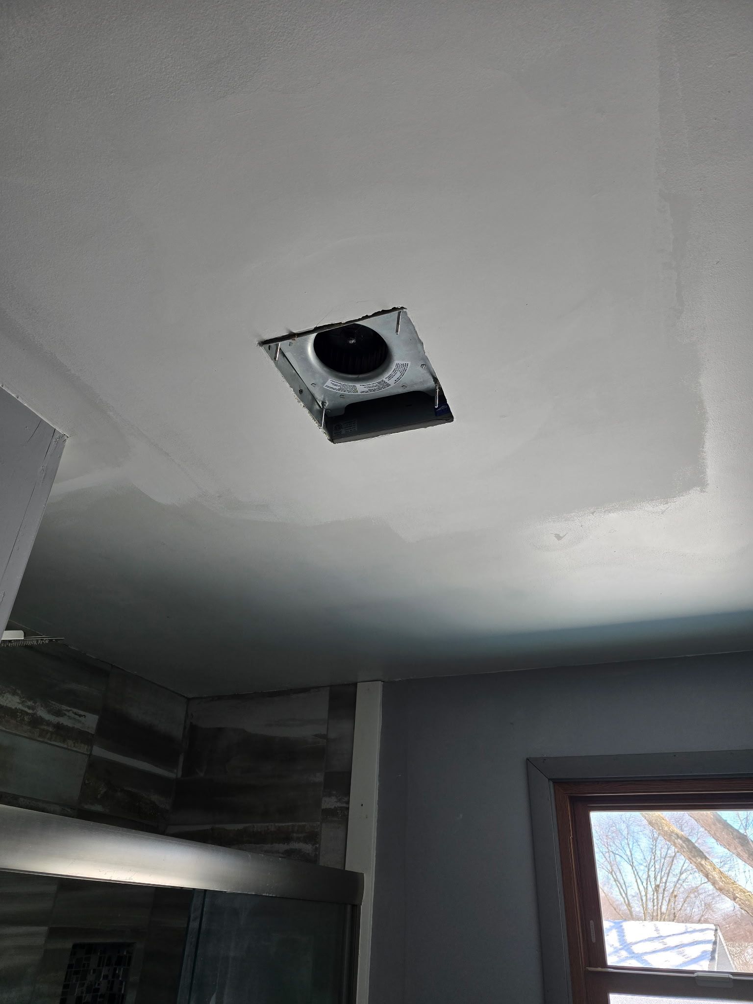 A fan is hanging from the ceiling of a room.