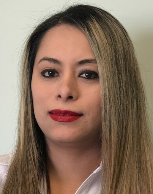 Close-up portrait of a person with long blonde hair, red lipstick, and a white-collared shirt