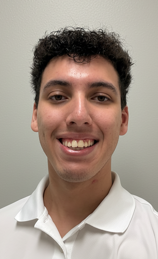 Smiling person in a white polo shirt against a plain light background