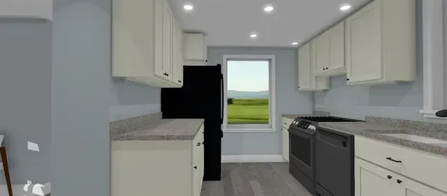Bright modern kitchen with white cabinets, gray countertops, and a window view at the back