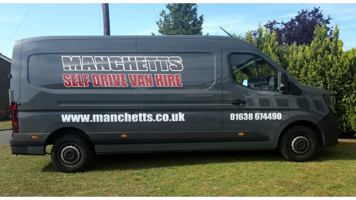 Grey Manchetts service van parked on grass with website and phone number on the side