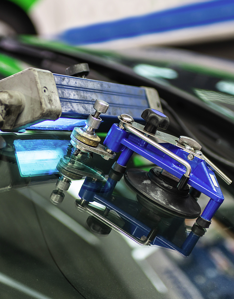 a man fixing a windscreen crack