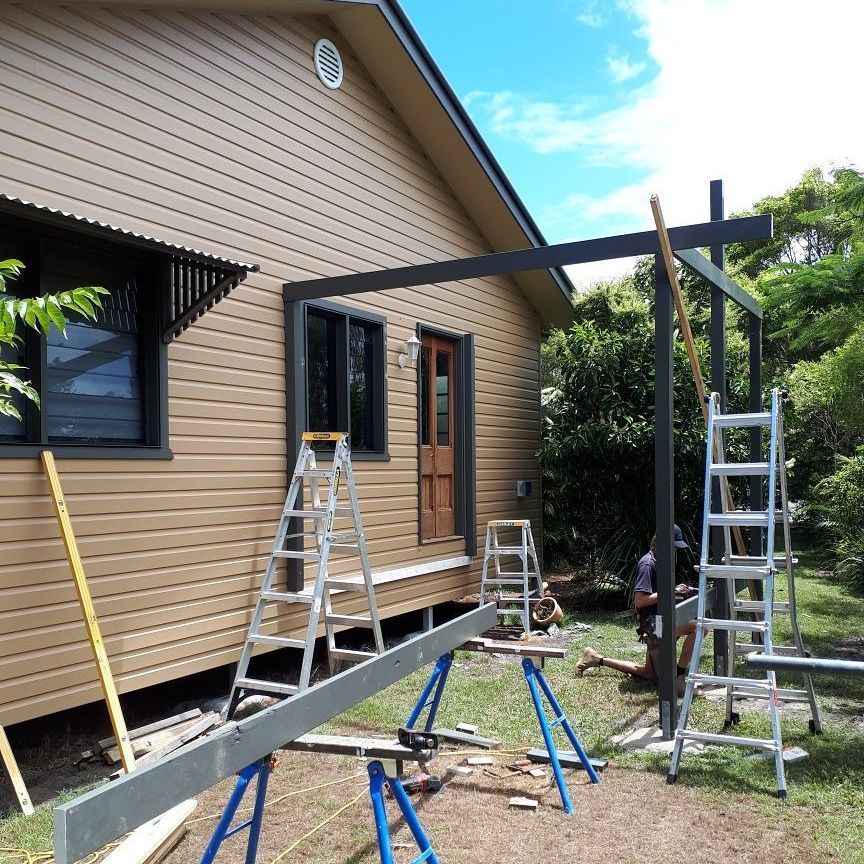 A House Is Being Built With A Ladder In Front Of It — Pottsville Carpentry and Home Maintenance In Pottsville, NSW