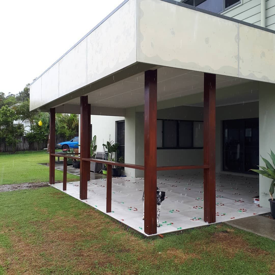 A House With A Covered Porch And A Lawn In Front Of It — Pottsville Carpentry and Home Maintenance In Pottsville, NSW