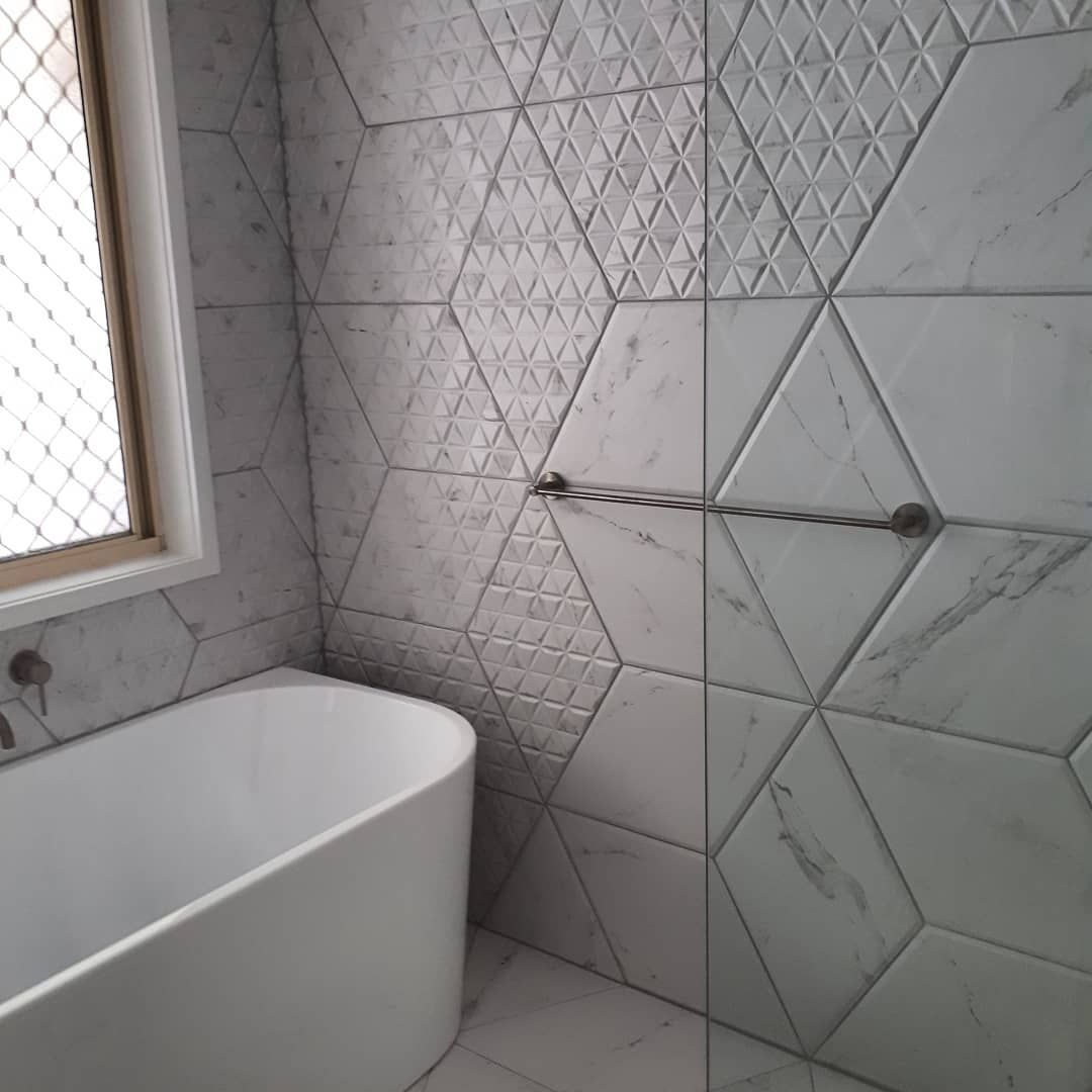 A Bathroom With A Bathtub, Shower, And Hexagonal Tiles — Pottsville Carpentry and Home Maintenance In Pottsville, NSW