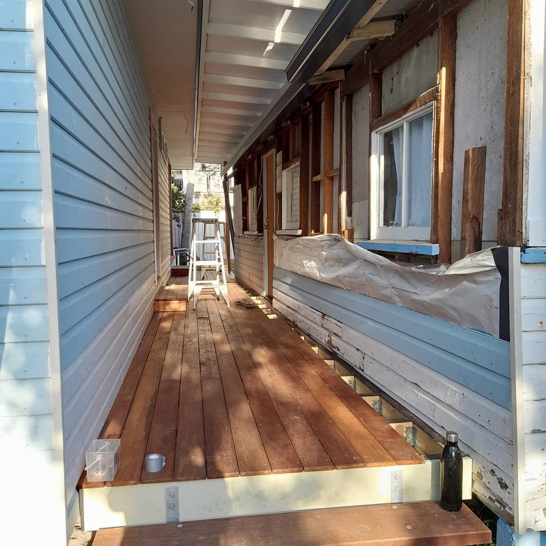 A Wooden Walkway Between Two Buildings With A Ladder — Pottsville Carpentry and Home Maintenance In Pottsville, NSW