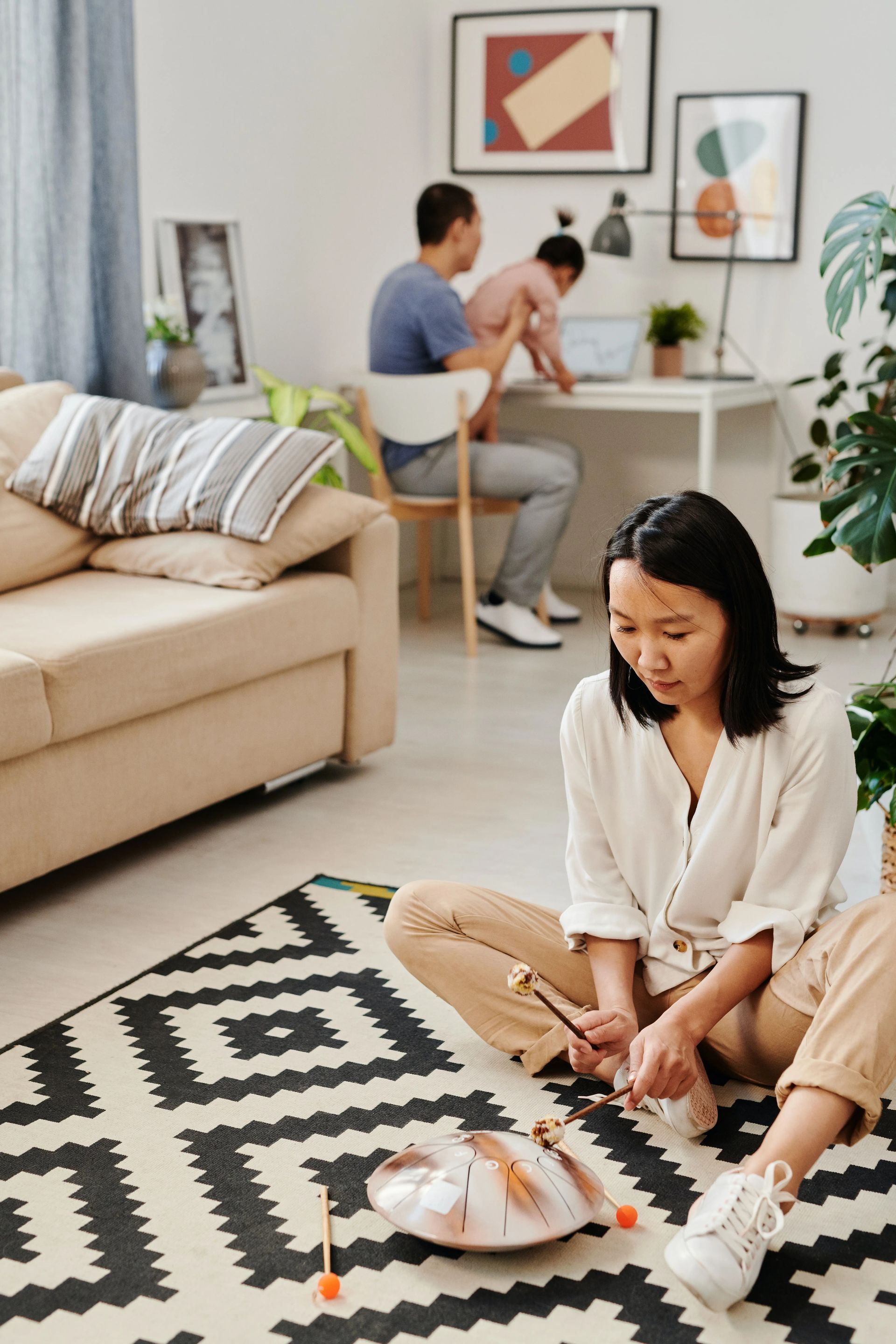 Woman Sitting on Floor Playing Instrument