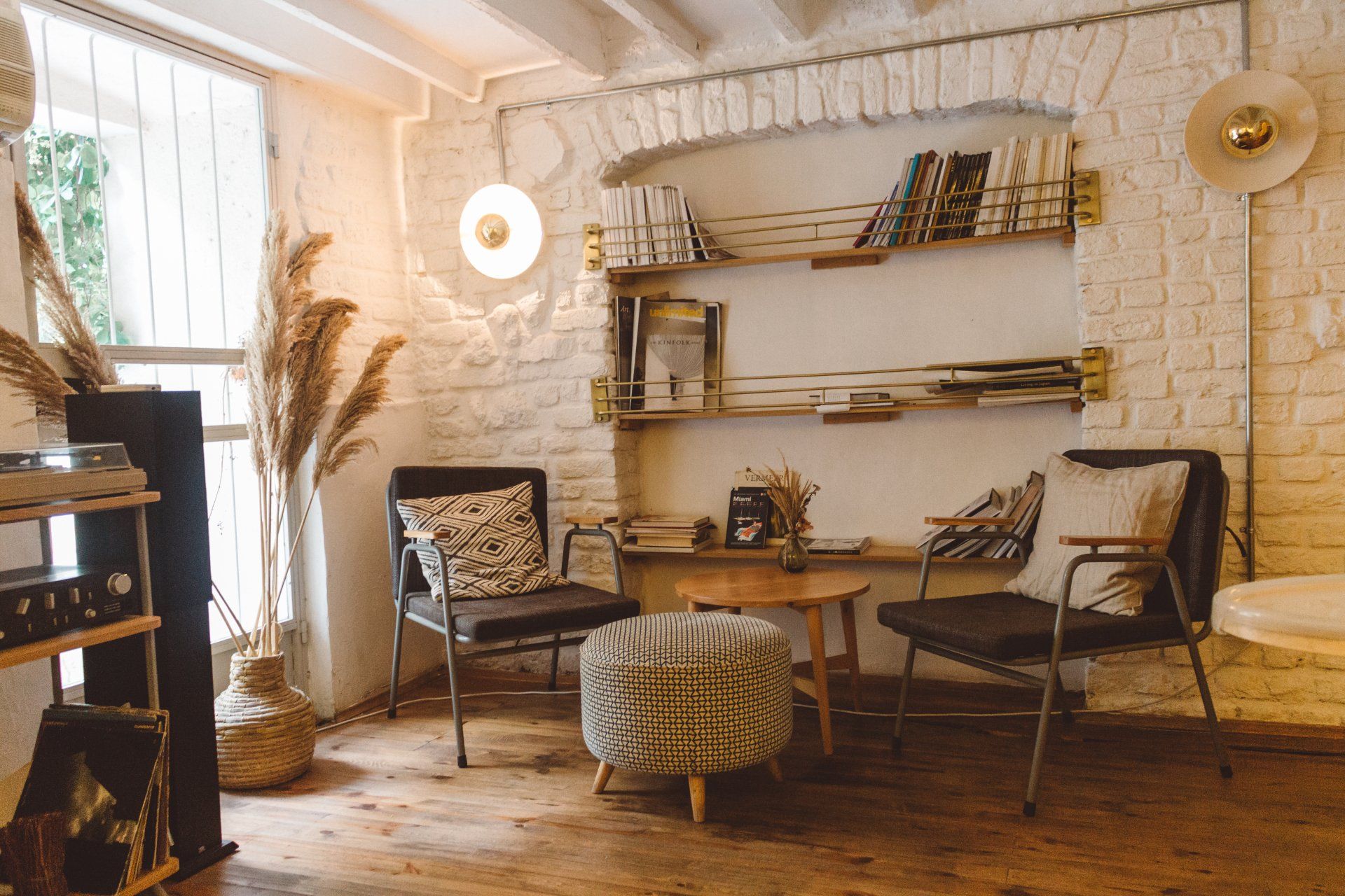 A Living Room Filled with Furniture and A Brick Wall