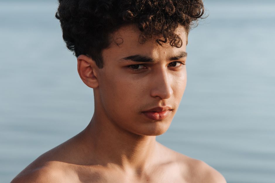 Young adult with oily skin looking at skincare options in Seoul