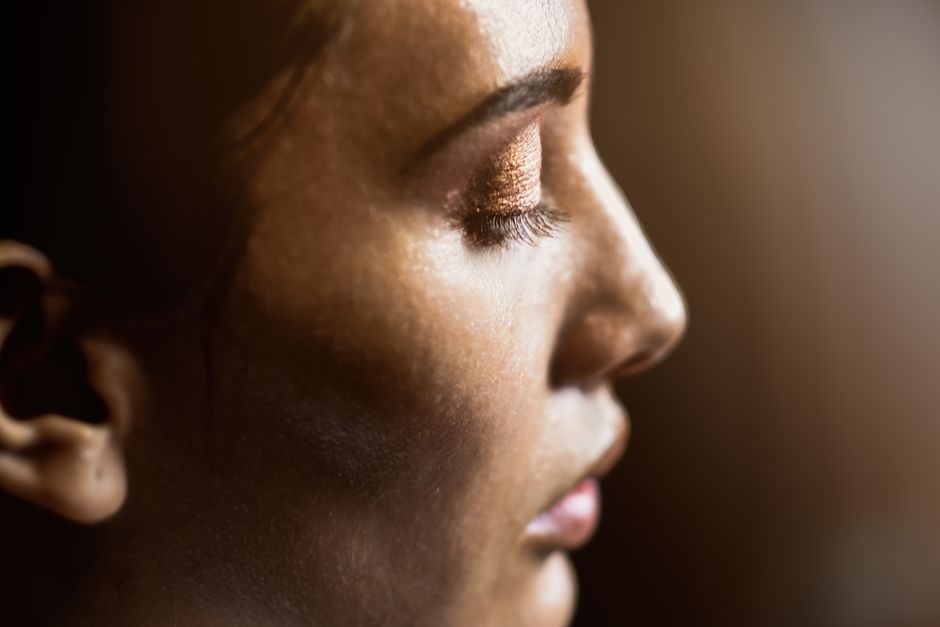 Woman with bright, radiant skin after brightening treatment in Seoul