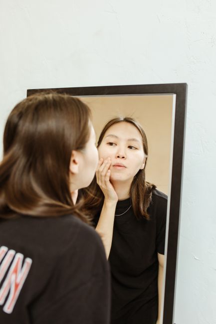 Patient checking skin at home during follow-up care after treatment in Seoul