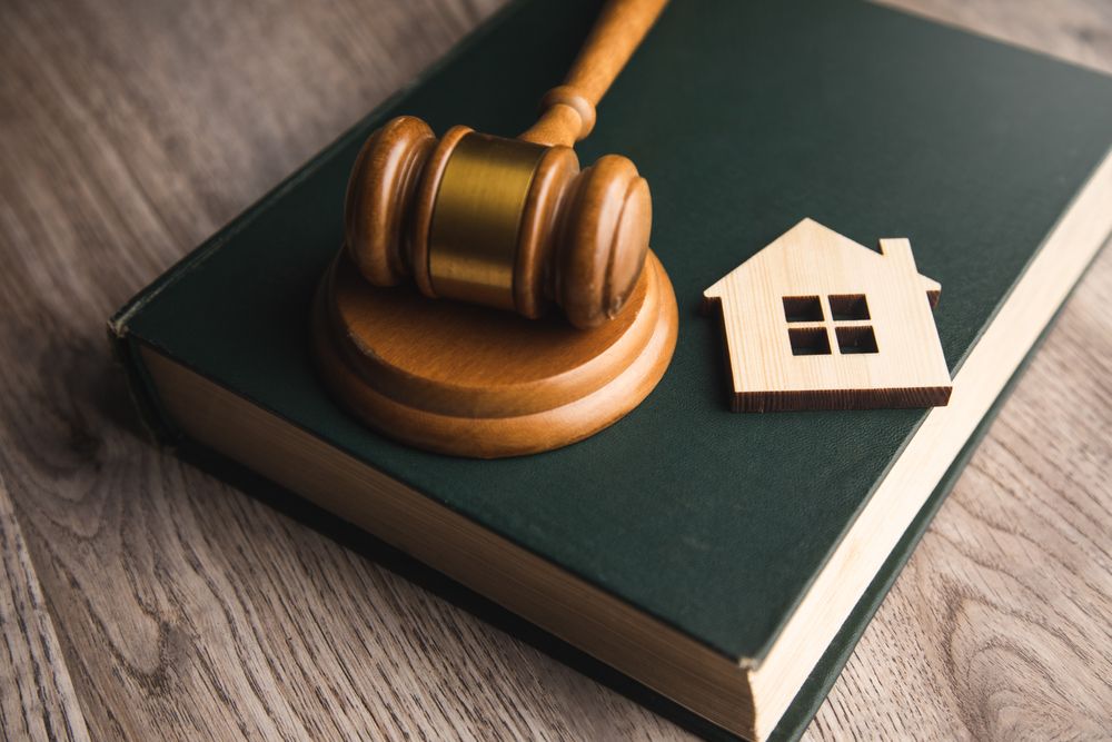 House Model With Gavel and Law Book