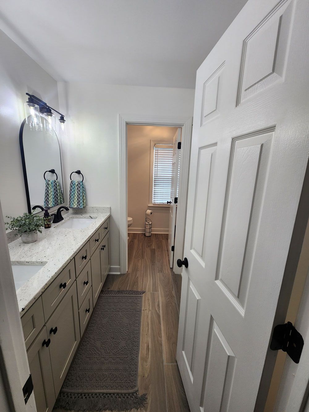 A bathroom with a sink , mirror , and toilet.