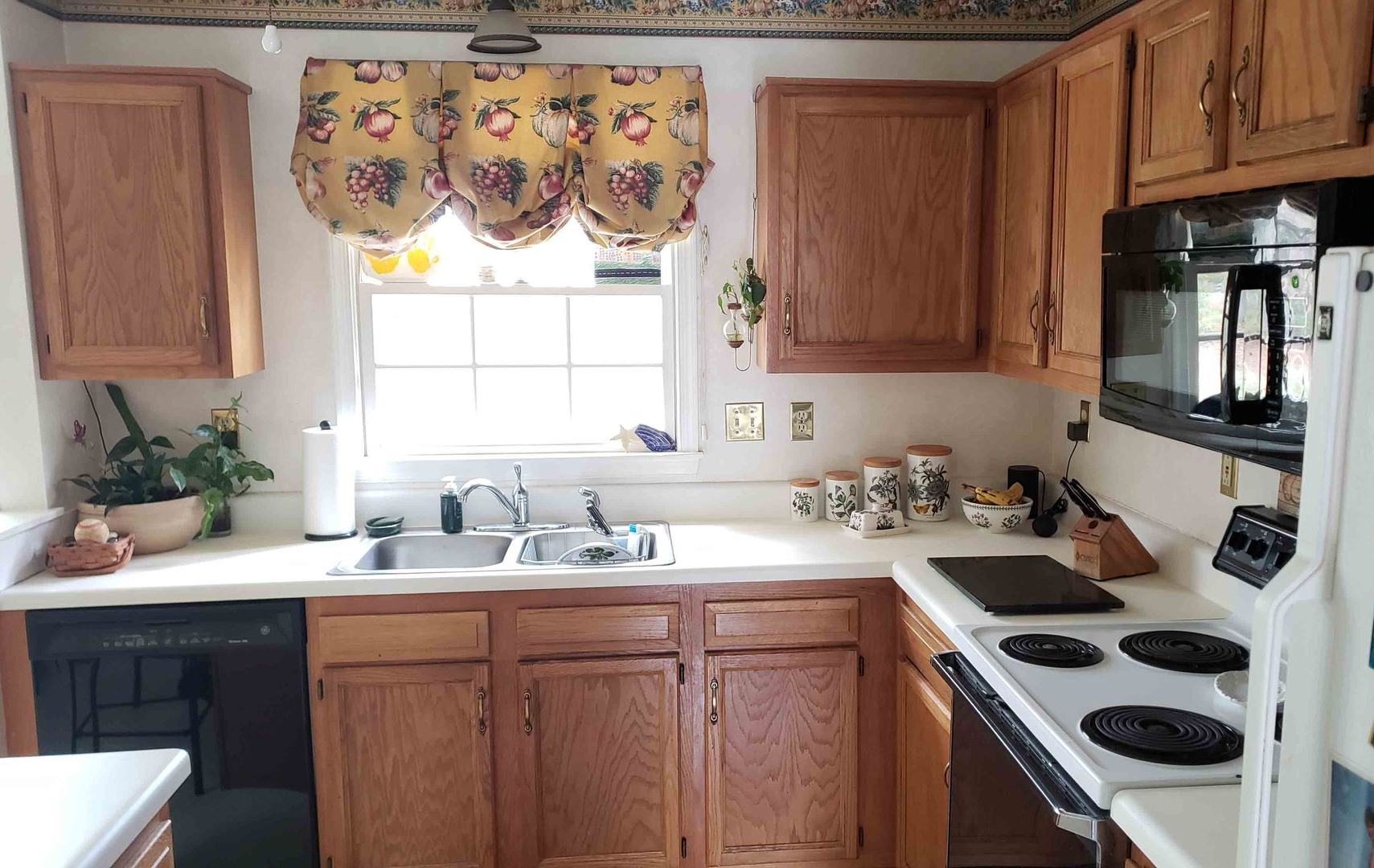 A kitchen with wooden cabinets and a white refrigerator