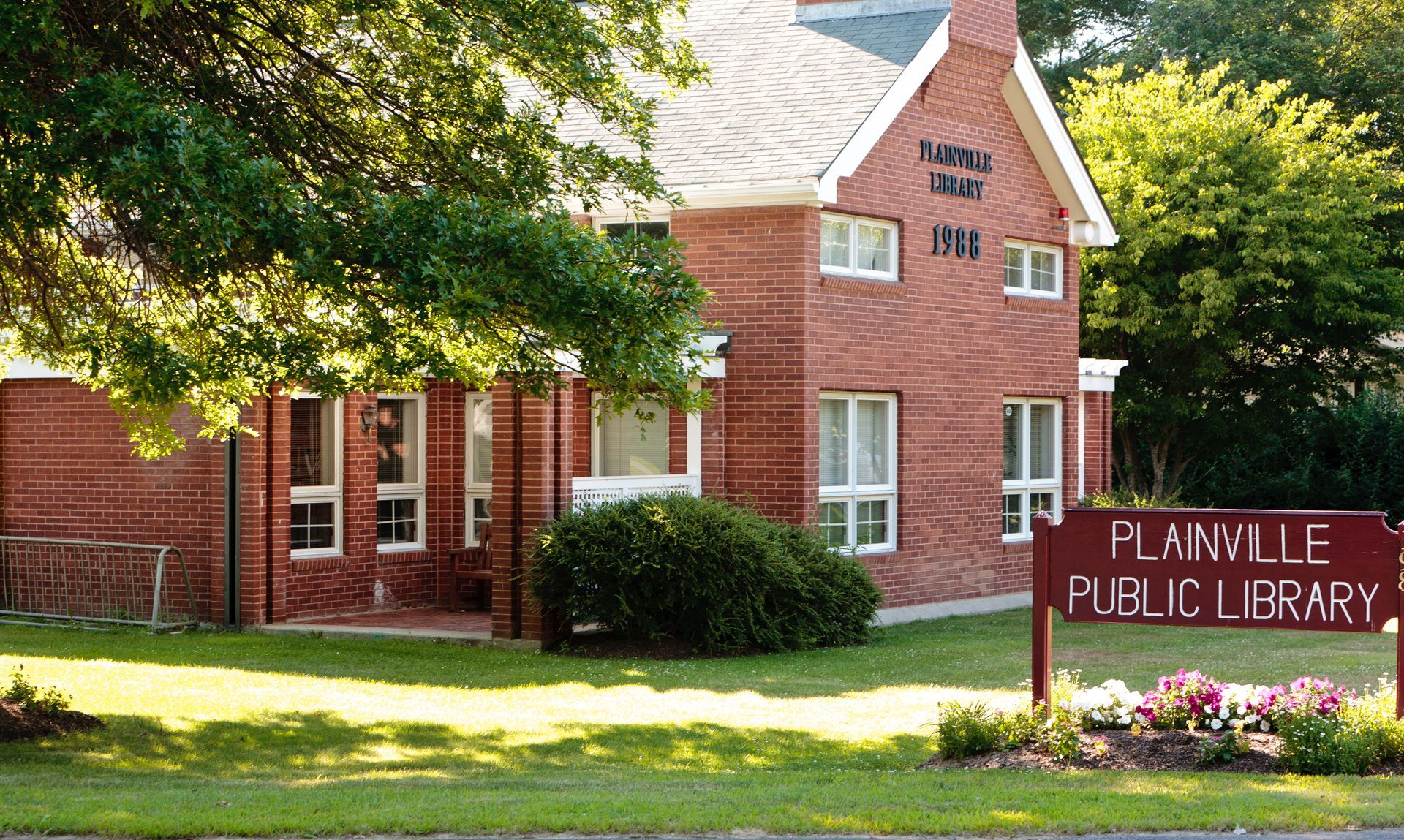 Brick public library building with sign reading 