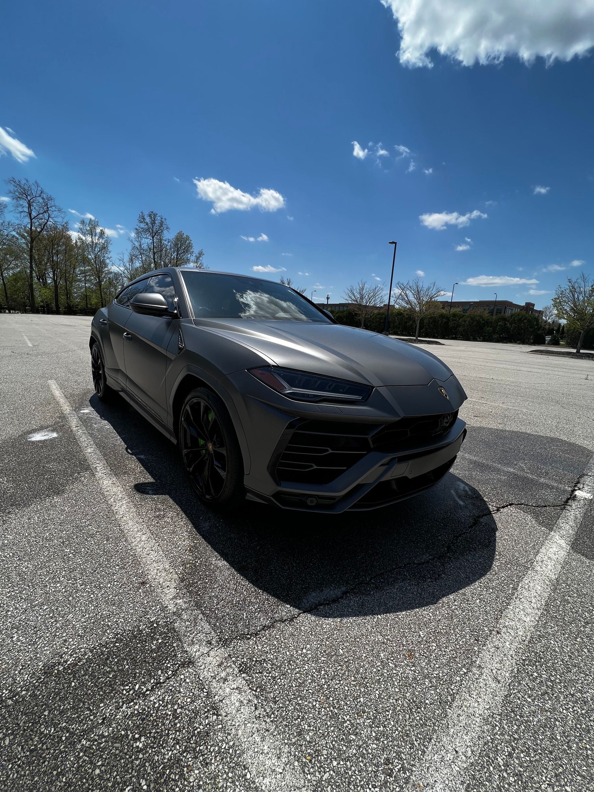 A car is parked in a parking lot on a sunny day