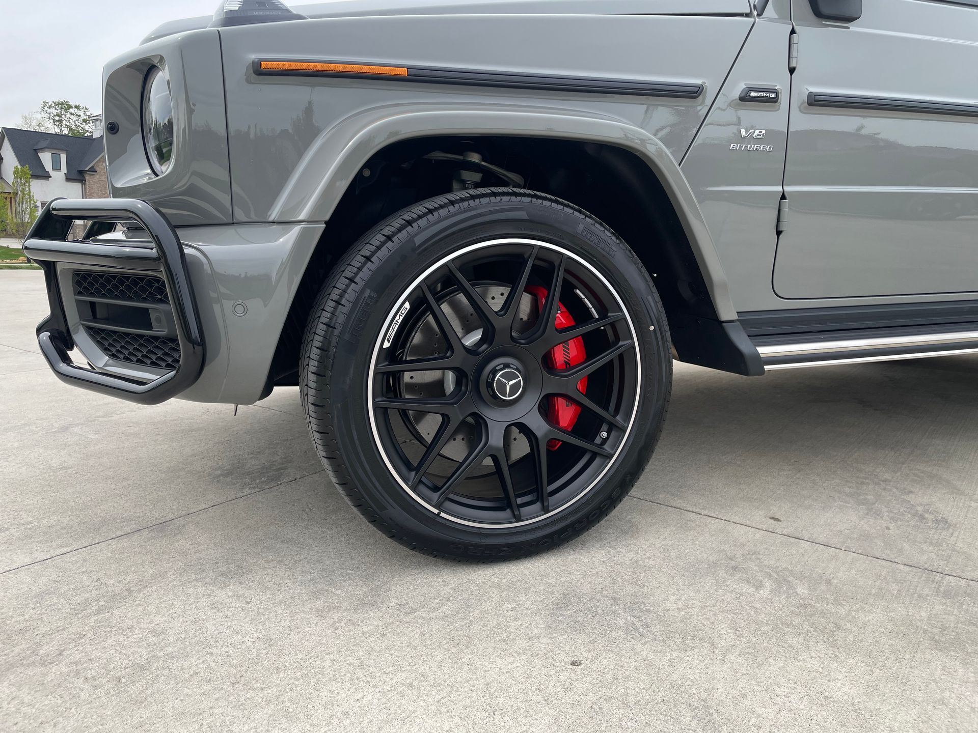 A mercedes benz g63 amg is parked in a parking lot.