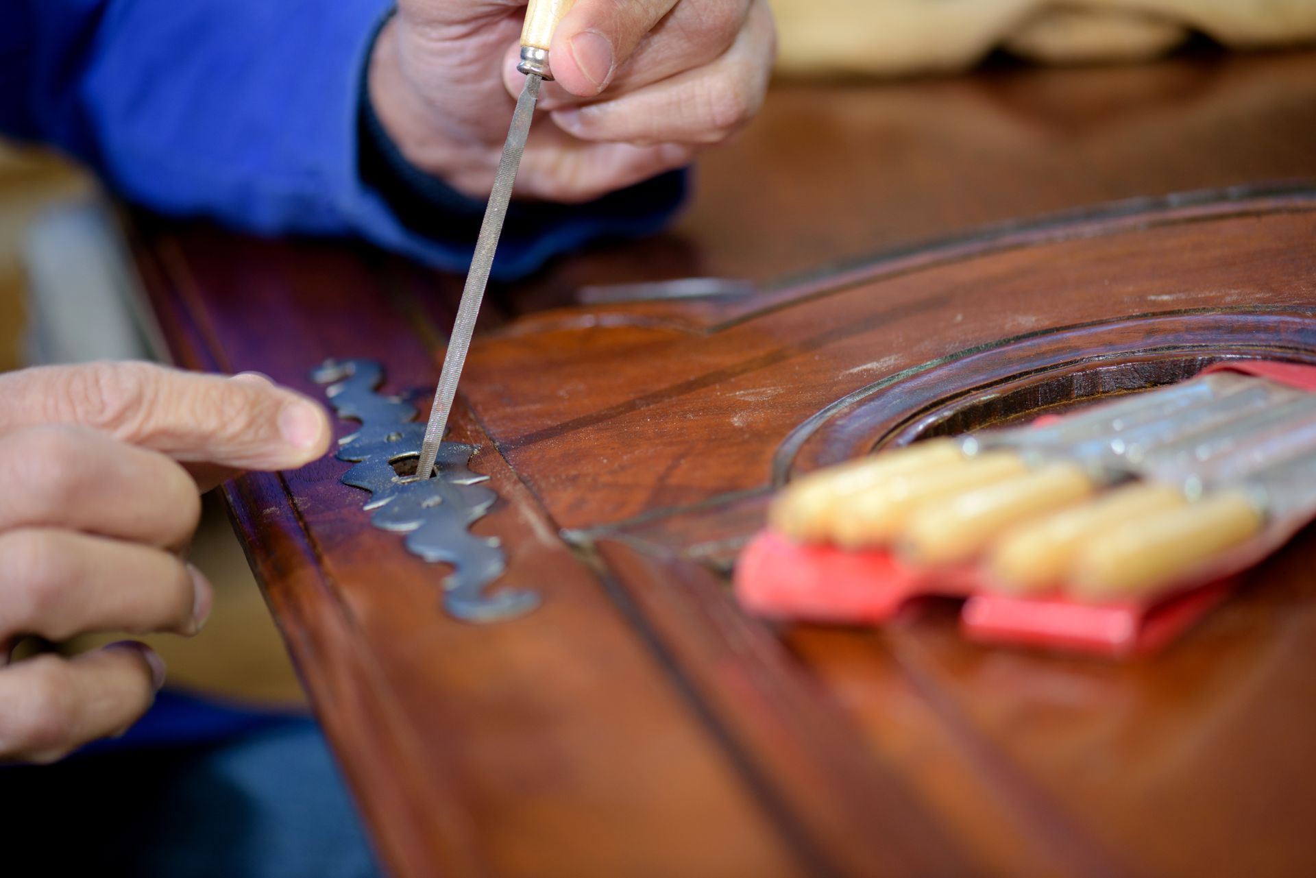 A person is working on a piece of wood with a screwdriver.