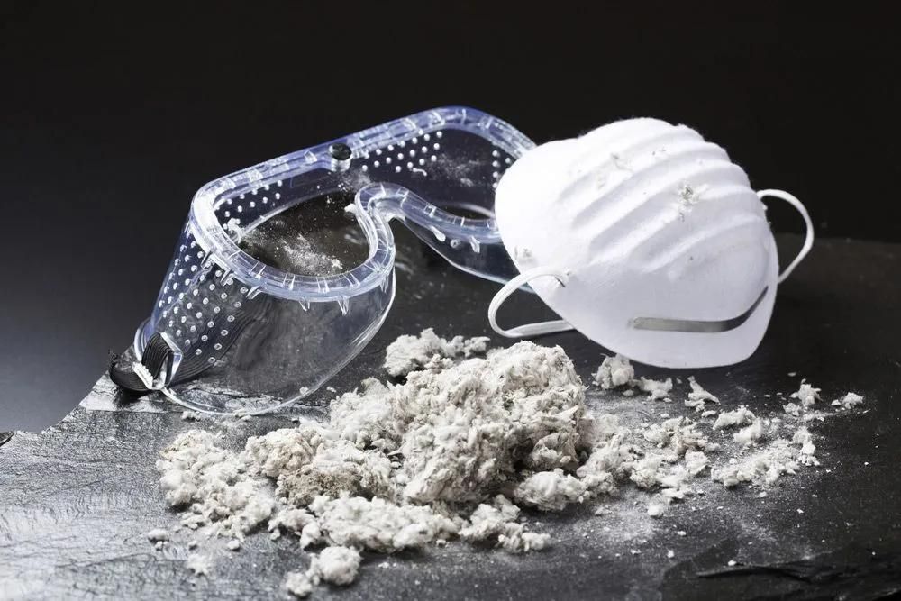 A Mask and Goggles Are Sitting on A Pile of Dust — Central Coast Complete Demolition & Tree Service in Buff Point, NSW