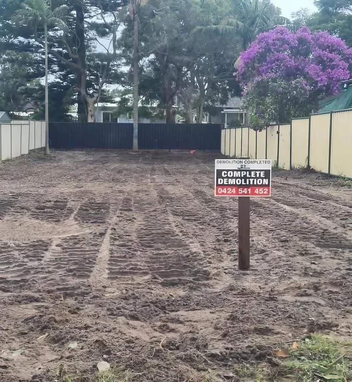 A Dirt Road with A Sign that Says Complete Demolition — Central Coast Complete Demolition & Tree Service in Buff Point, NSW