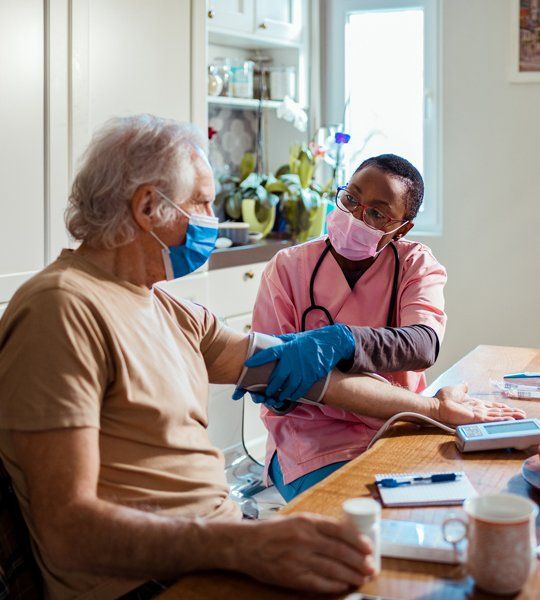 Senior Man Getting Blood Pressure By His Nurse — Austintown, OH — Moonlight Home Health Care Senior Man Getting Blood Pressure By His Nurse — Austintown, OH — Moonlight Home Health Care