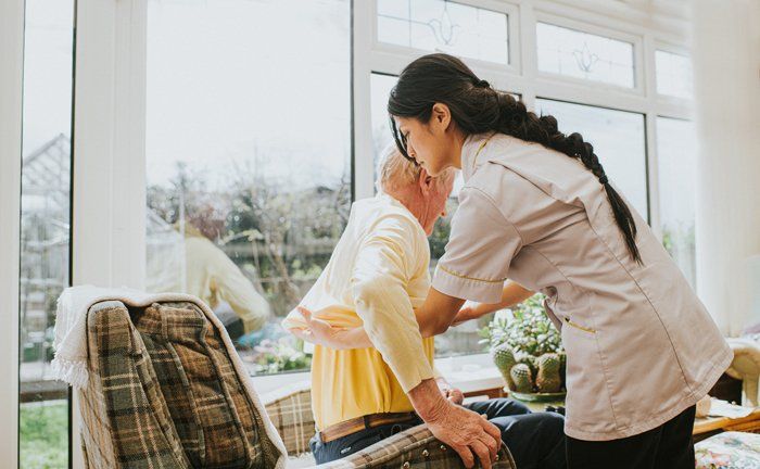 Young Care Assistant Helps Senior Man — Austintown, OH — Moonlight Home Health Care Young Care Assistant Helps Senior Man — Austintown, OH — Moonlight Home Health Care