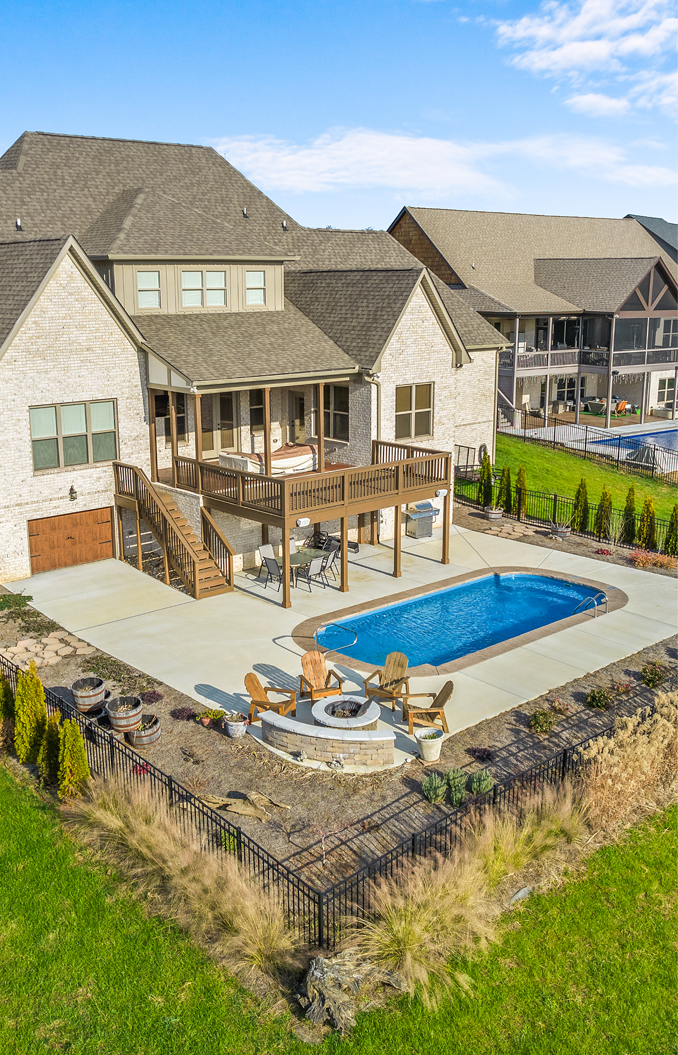 fiberglass pool installation in Mt. Juliet Tennessee luxury backyard with modern deck and blue water