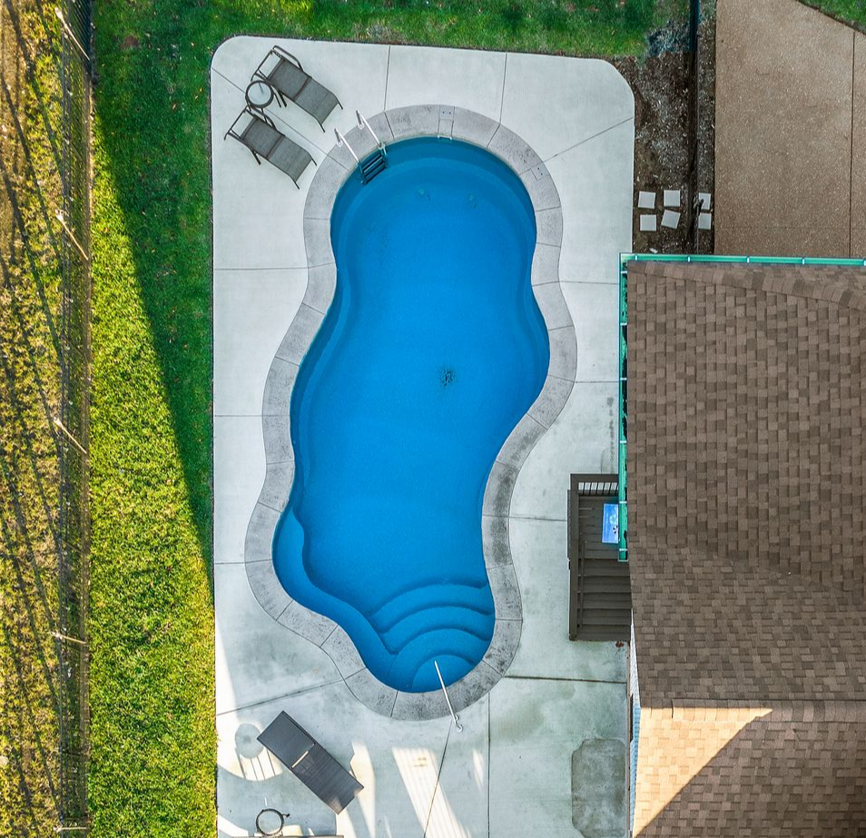custom vinyl liner pool installation in Mt. Juliet Tennessee backyard with patio and construction site