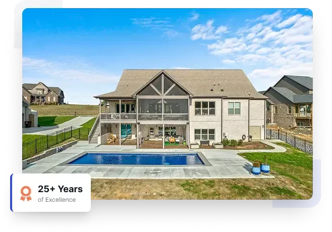 Modern two-story suburban house with a backyard pool and patio under a blue sky