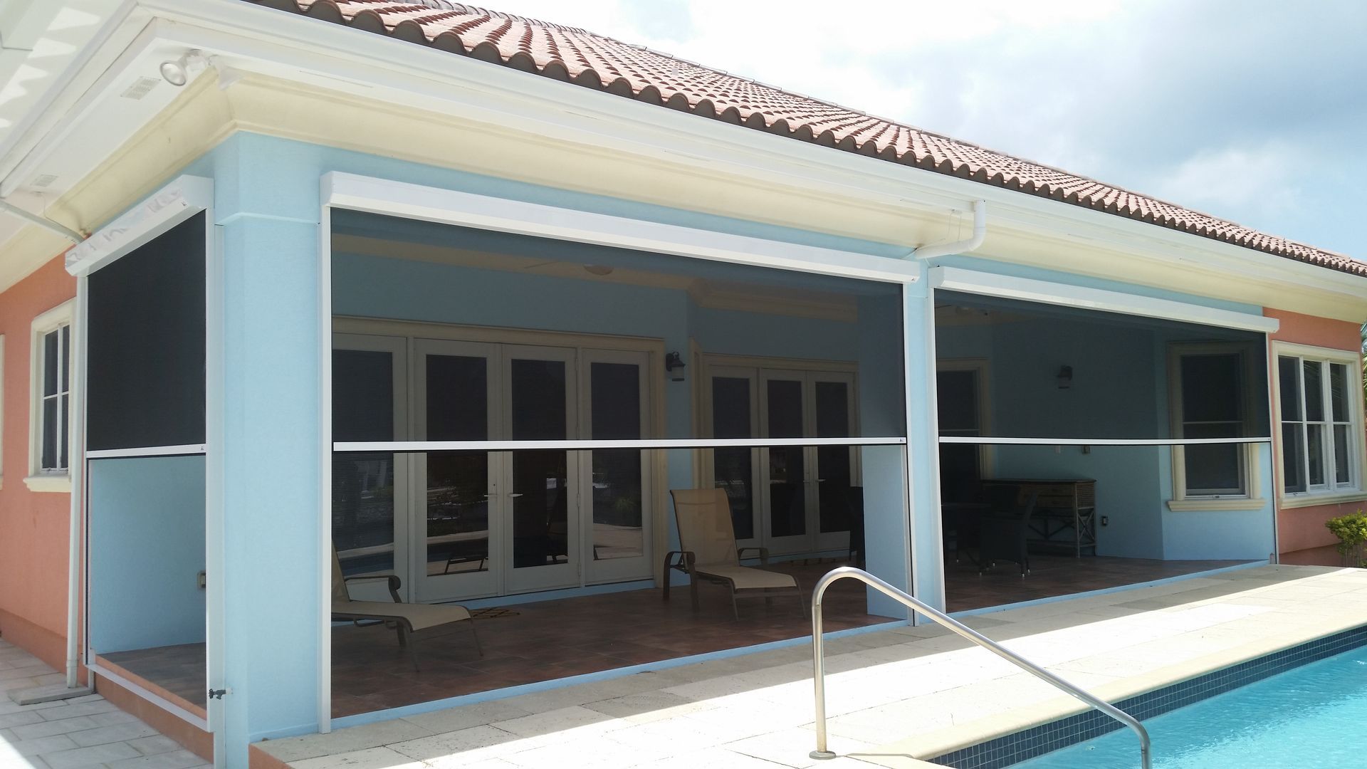 A house with a swimming pool in front of it