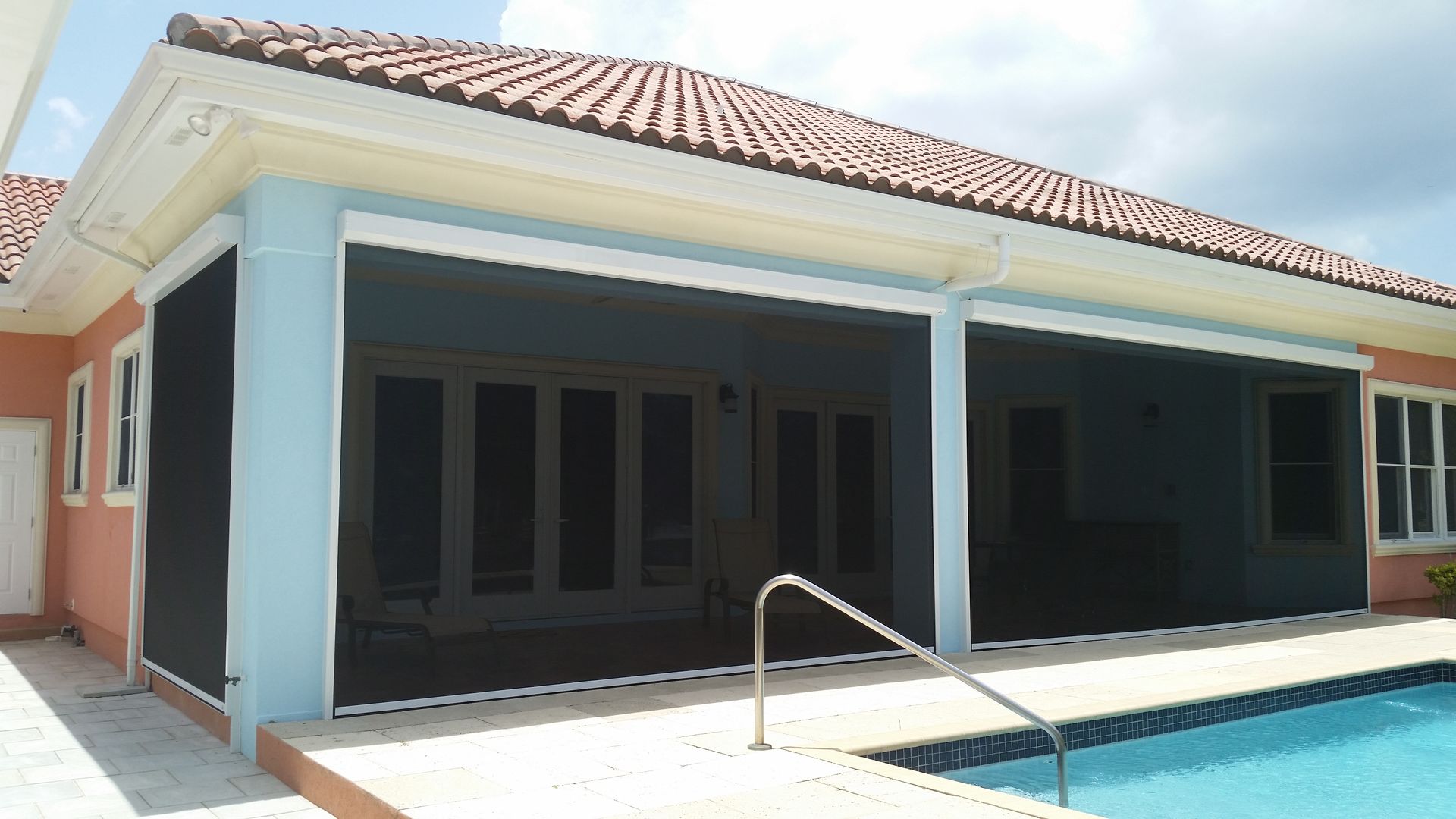 A house with a swimming pool in front of it