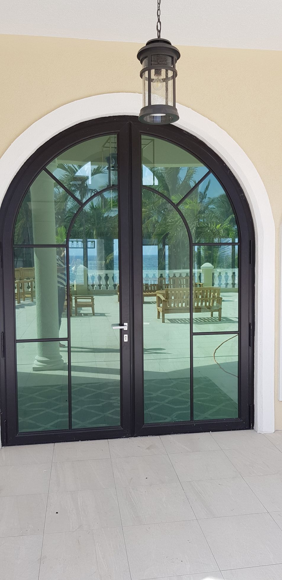 There is a lantern hanging from the ceiling above the door.