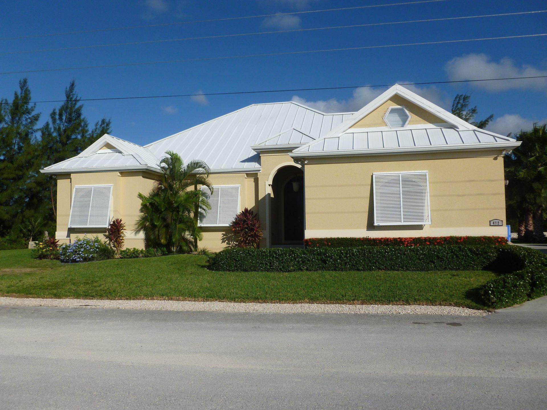 A large yellow house with a white roof