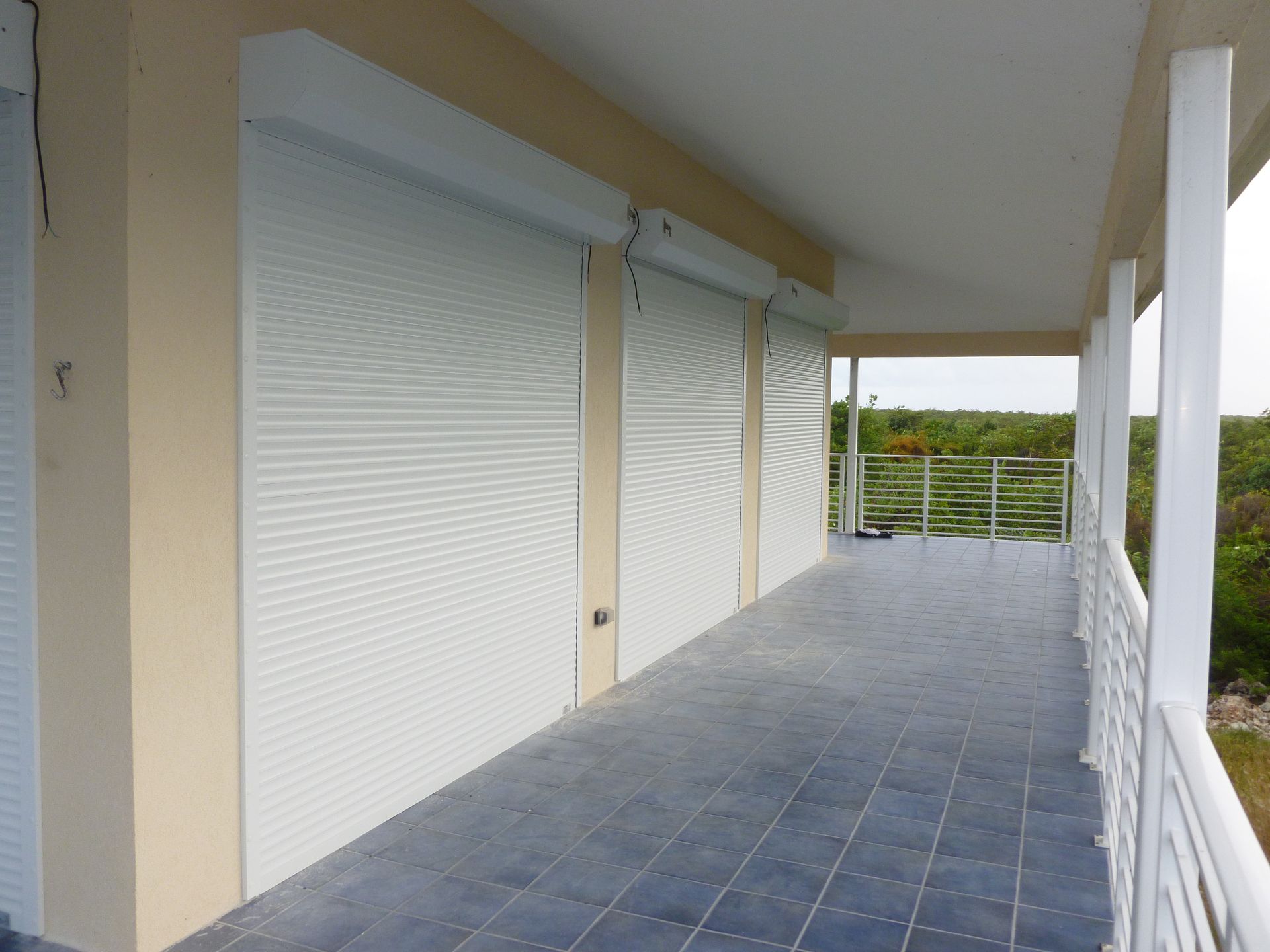 A balcony with white shutters and the number 8 on the wall