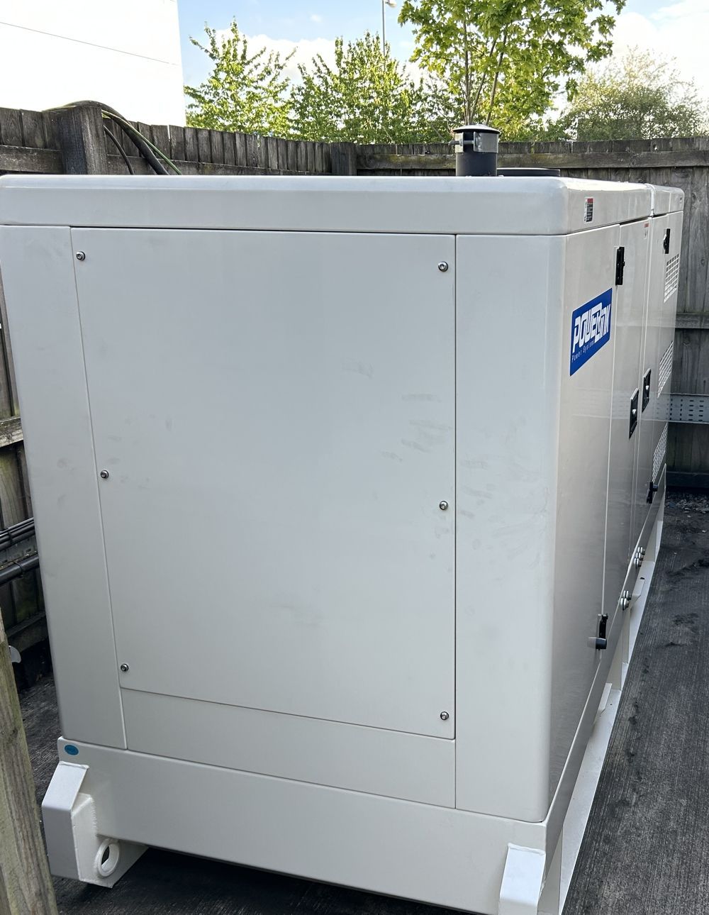White industrial generator outdoors.