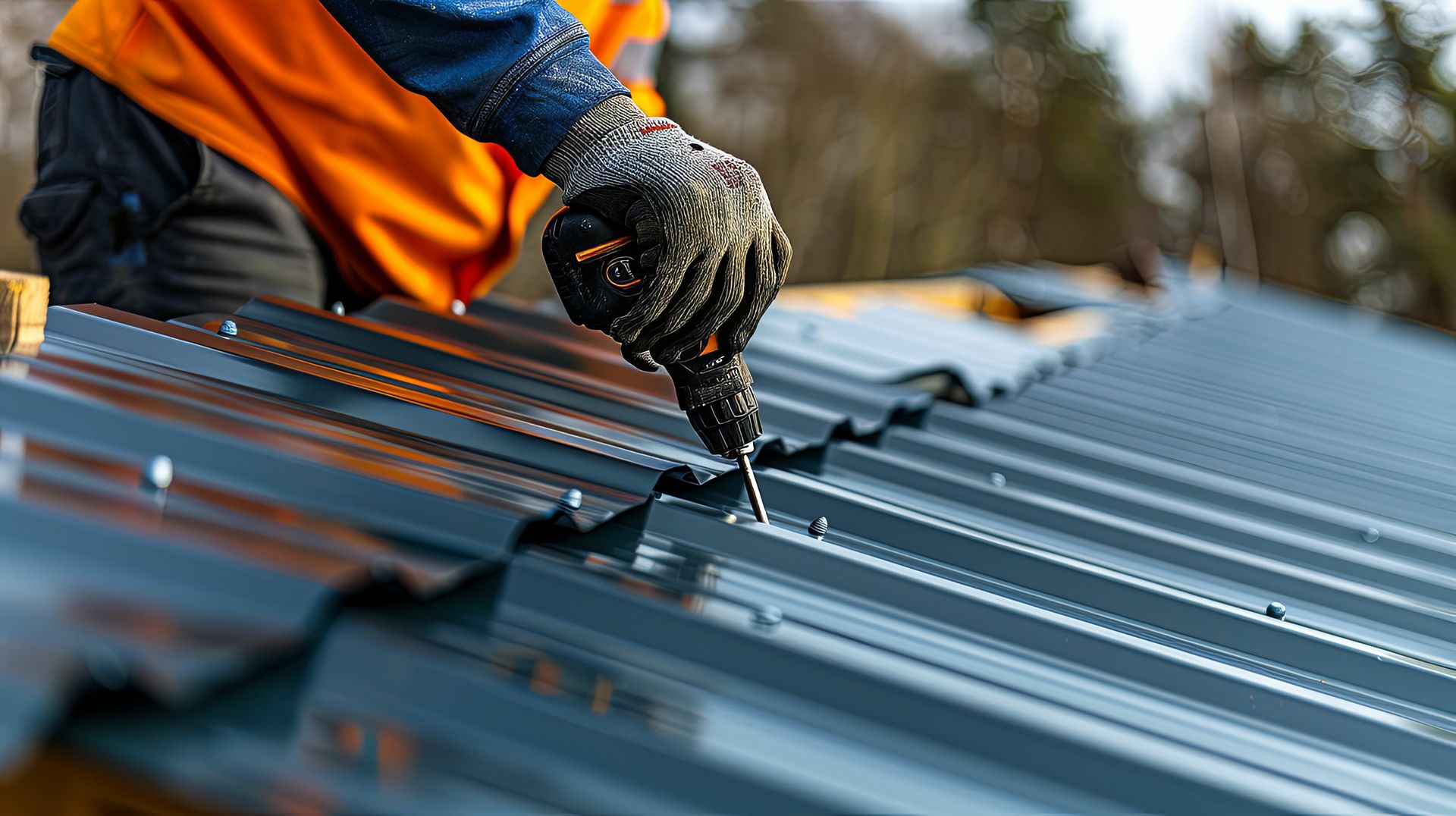 A man is fixing a metal roof with a screwdriver.