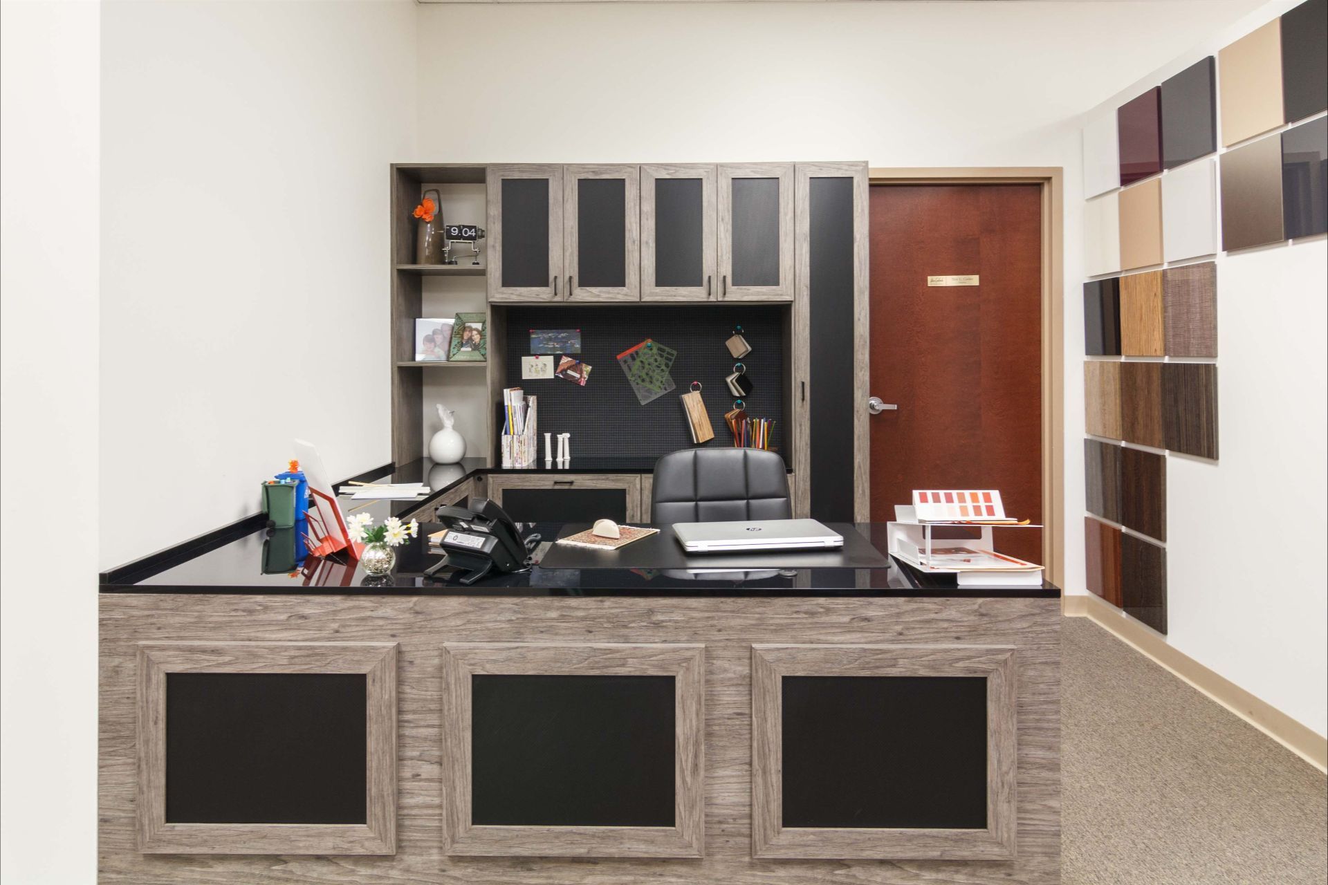 White kitchen cabinets with shelves, storing food items, wine bottles, and a red mixer, next to a wood-topped island.
