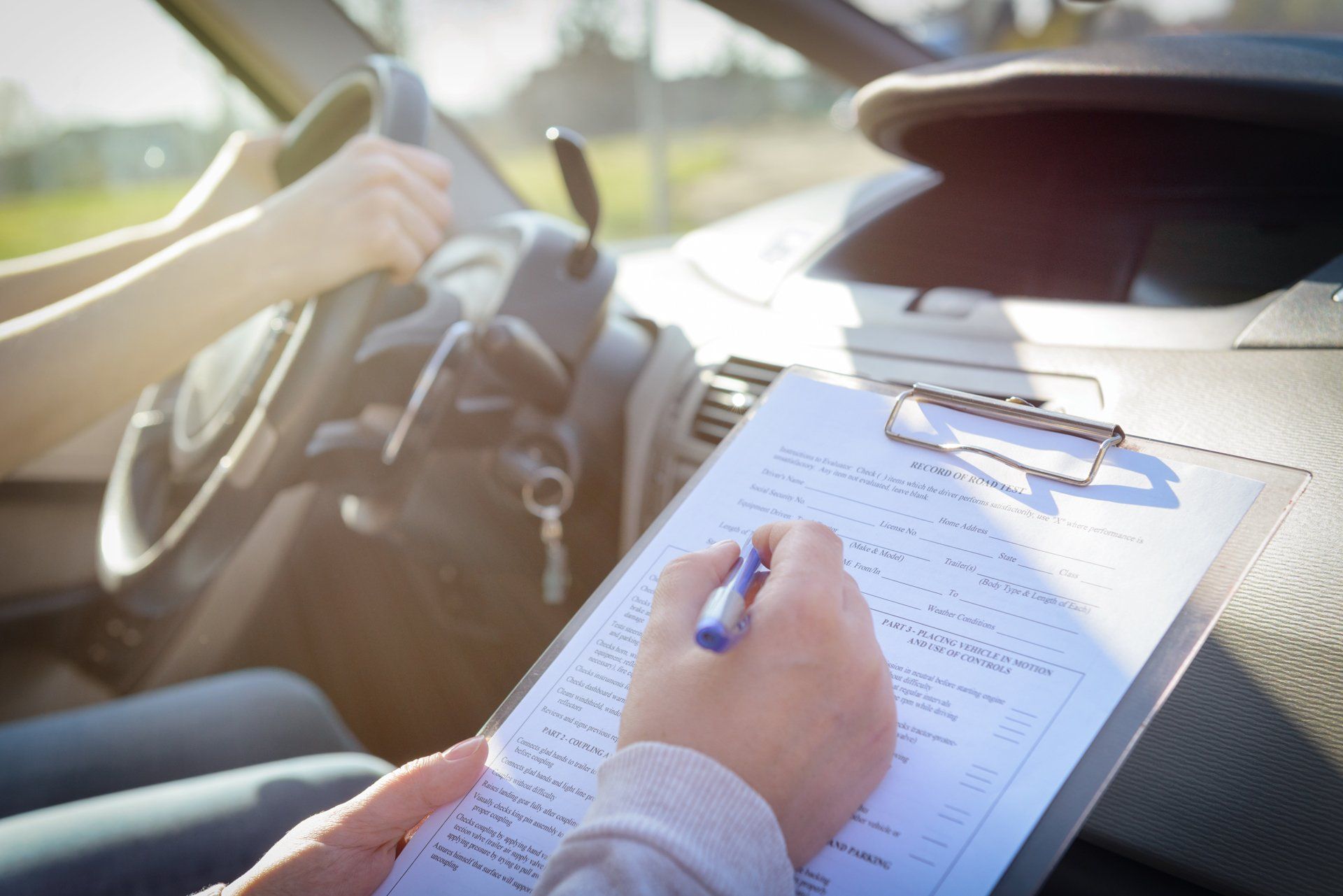 Professional Driving Instructor Doing Student Driver Assessment