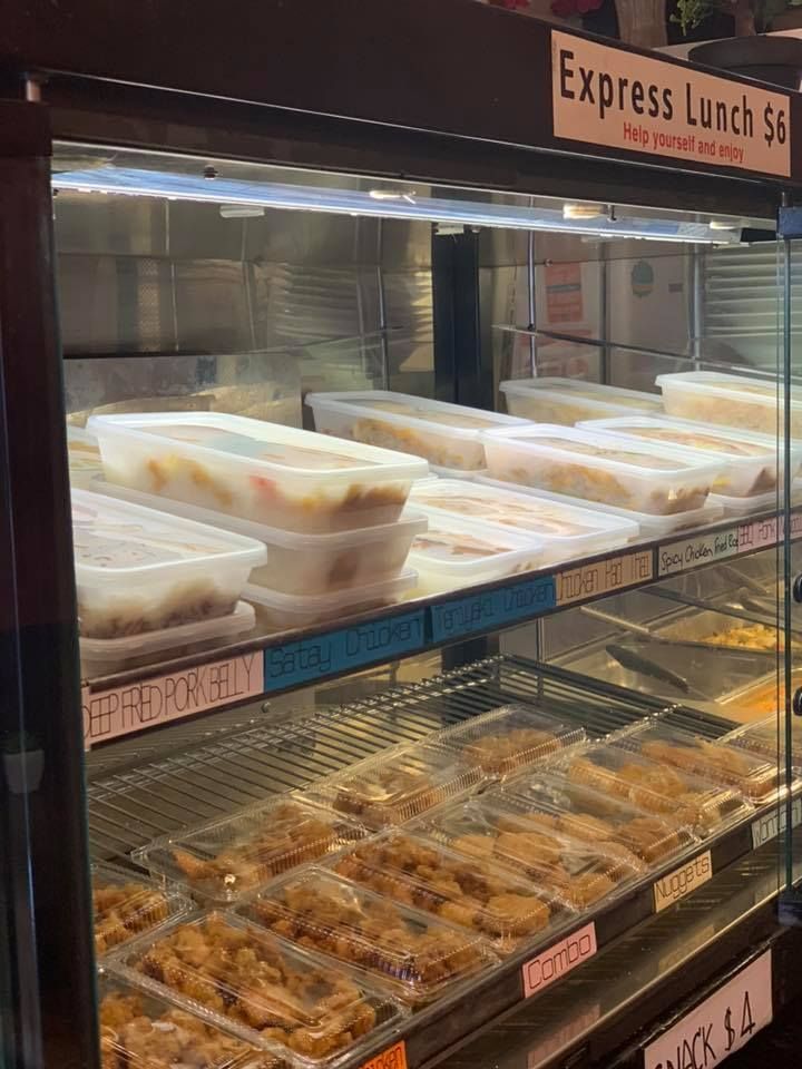 A display case filled with lots of food in plastic containers.