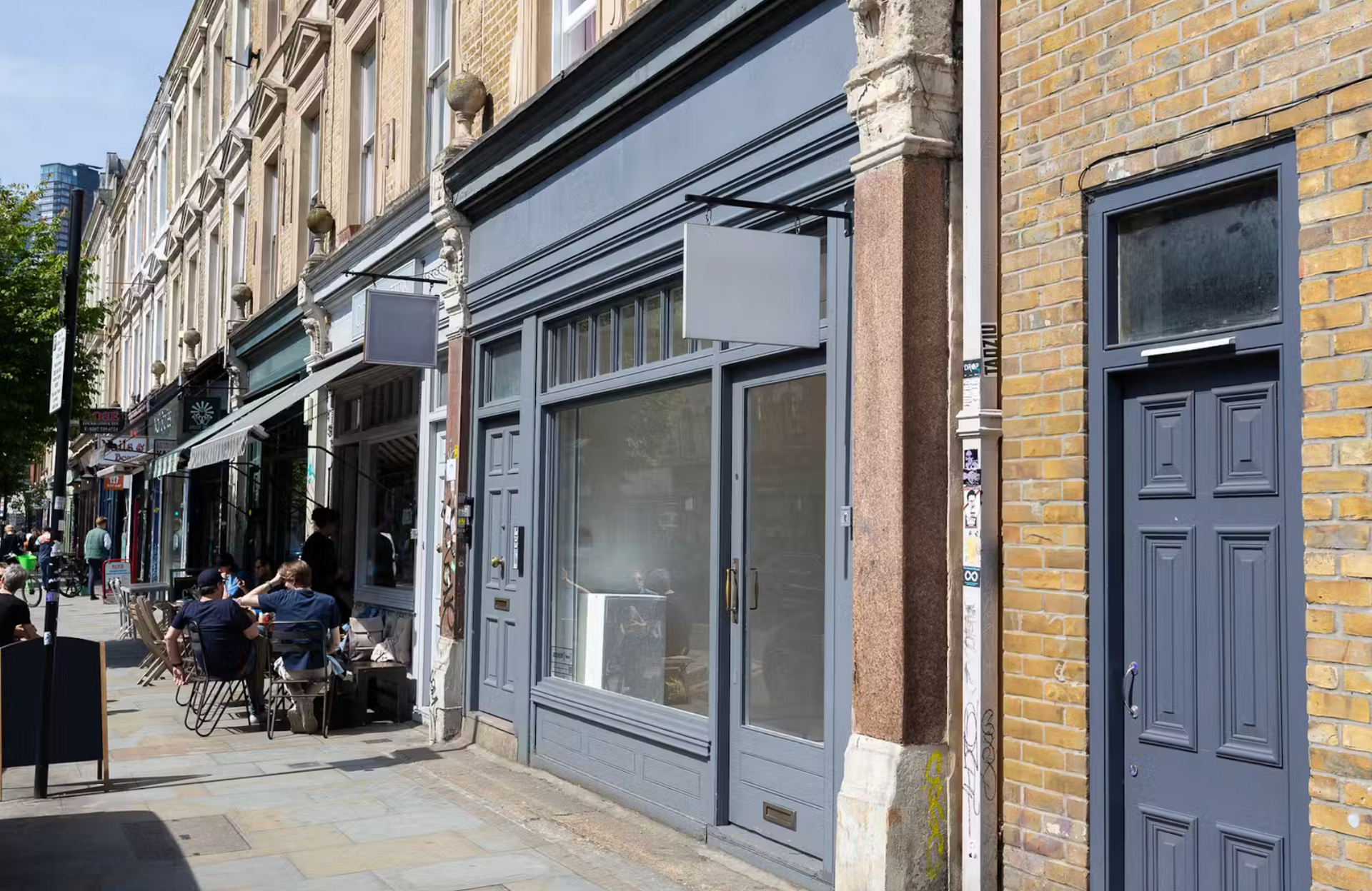 A row of shops are lined up on a city street
