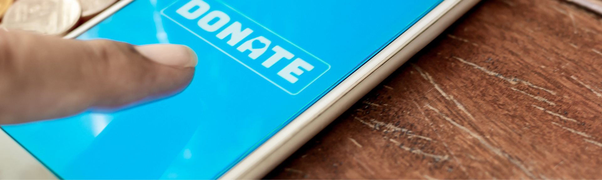Finger tapping a blue donate button on a smartphone screen