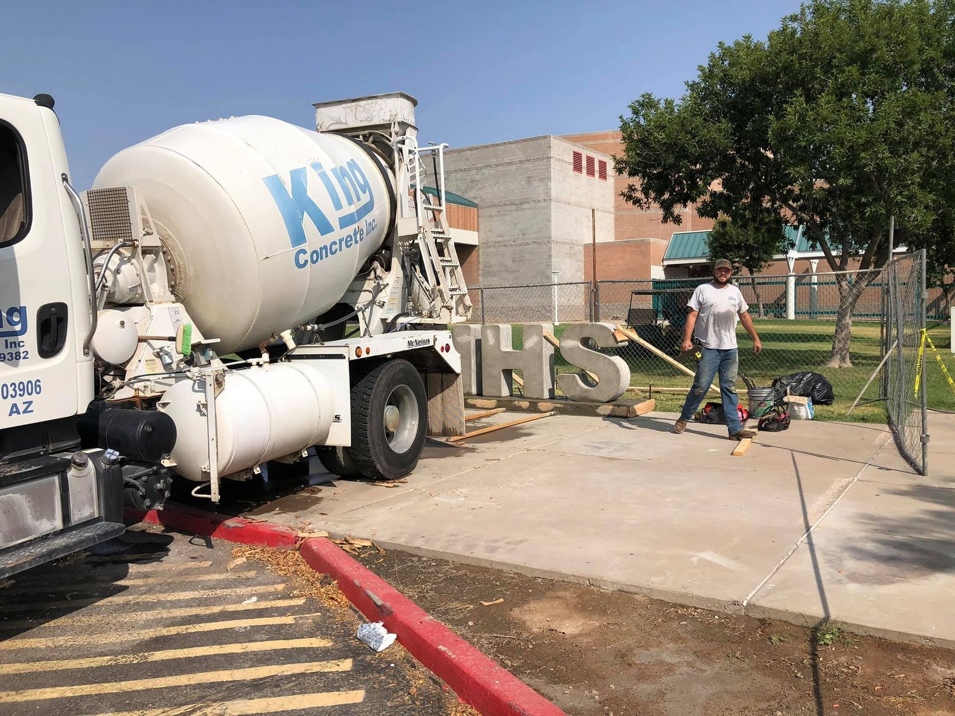 Sidewalk replacement pour with single-axle concrete truck at curb in Tempe, AZ neighborhood