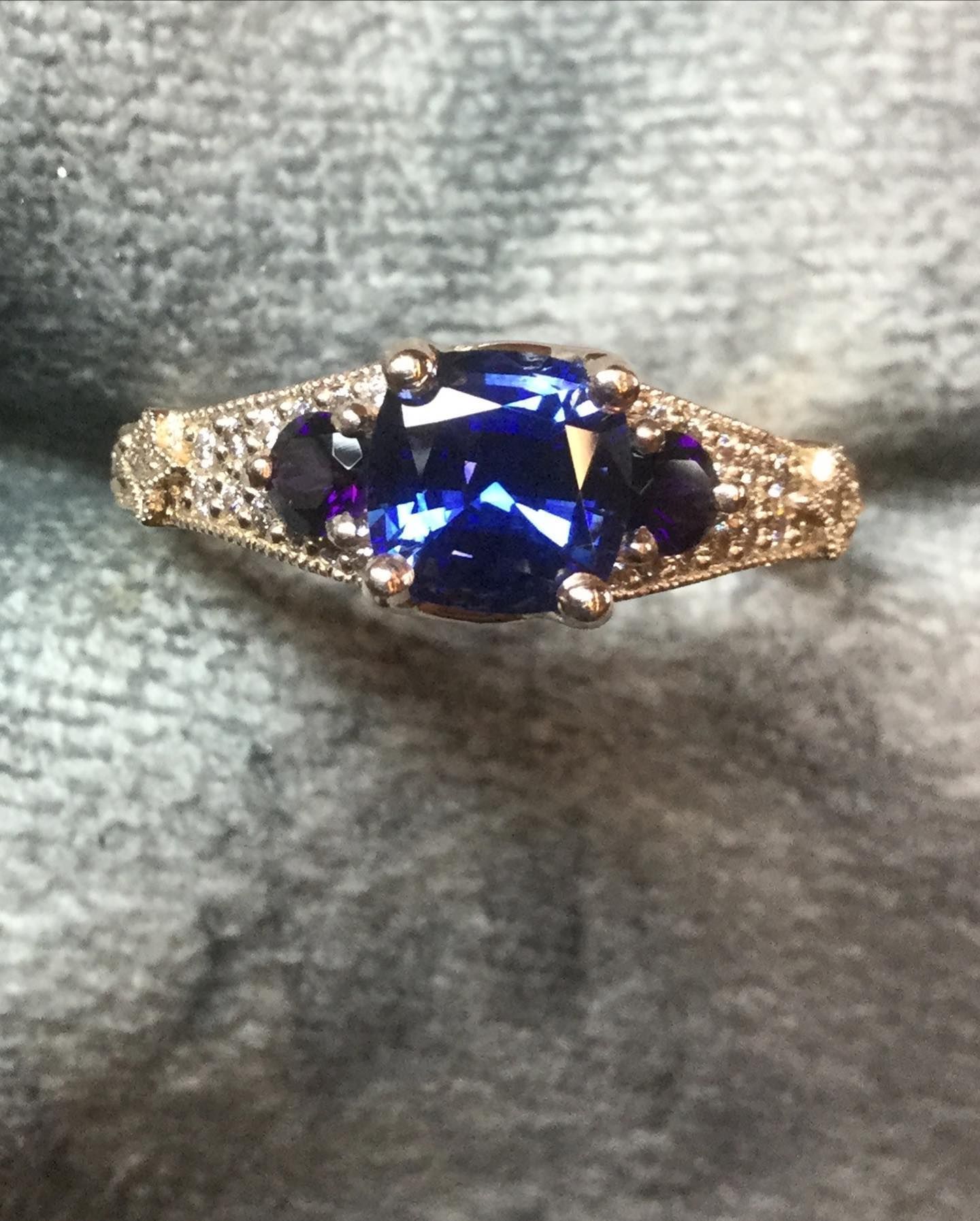 A gold ring with a blue stone in the center